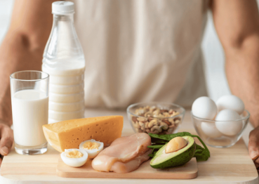 man with a board full of protein rich foods
